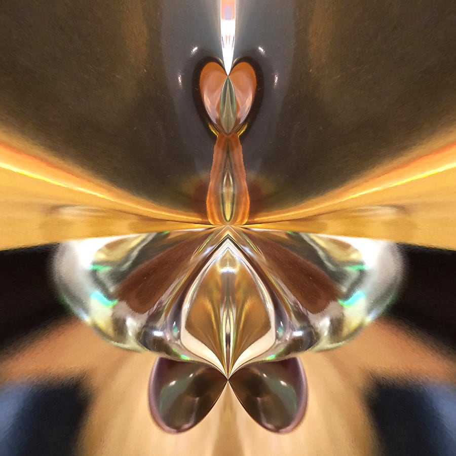 A digitally enhanced photograph by Vincent Prator. With gold and brown hues, this photograph of what may be a glass object looks to this interpreter like a glass butterfly or dragonfly. The image is abstract and very open to interpretation.